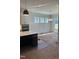 Dining area features bright windows, modern light fixture, and connects seamlessly to the kitchen space at 9000 Penny Rd, Raleigh, NC 27606