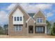 Newly built two-story brick home with gabled roofline and covered entryway at 9000 Penny Rd, Raleigh, NC 27606