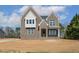 Beautiful two-story brick home with detailed windows and a welcoming covered entrance at 9000 Penny Rd, Raleigh, NC 27606