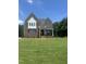 Beautiful two-story brick home featuring large front lawn and classic architectural details in a desirable neighborhood at 9000 Penny Rd, Raleigh, NC 27606