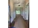 Bright hallway features modern light fixture, leading to an open living area and door openings on either side at 9000 Penny Rd, Raleigh, NC 27606