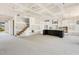 Spacious living room with staircase, kitchen area with black island, and white cabinets at 9000 Penny Rd, Raleigh, NC 27606