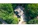 Aerial view showcasing the roof and landscaping of the home in a wooded setting at 9700 Pentland Ct, Raleigh, NC 27614