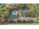 A beautiful aerial view of a neighborhood pool and tennis courts surrounded by lush trees at 9700 Pentland Ct, Raleigh, NC 27614