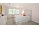 Bright bedroom with neutral carpet, tufted headboard, and charming decor at 9700 Pentland Ct, Raleigh, NC 27614