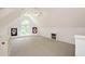Bonus room with neutral walls and carpeting. Features a large arched window at 9700 Pentland Ct, Raleigh, NC 27614