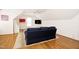 Cozy bonus room featuring hardwood floors, a comfy couch and modern decor at 9700 Pentland Ct, Raleigh, NC 27614