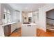 Elegant kitchen with white cabinetry, marble countertops, and a central island at 9700 Pentland Ct, Raleigh, NC 27614
