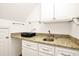 Bright laundry room featuring granite countertops, cabinets, and modern fixtures at 9700 Pentland Ct, Raleigh, NC 27614