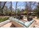 Outdoor patio with comfortable seating, grill, and lush greenery at 9700 Pentland Ct, Raleigh, NC 27614
