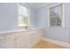 Bright wet bar with white cabinets, marble countertops, gold hardware, and natural light at 9700 Pentland Ct, Raleigh, NC 27614