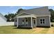 Inviting covered back porch with white columns and ceiling fan, perfect for outdoor relaxation at 1039 N Lincoln St, Benson, NC 27504