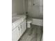 Bright bathroom features a vanity, toilet, and shower-tub combination at 1039 N Lincoln St, Benson, NC 27504