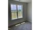 Sunlit bedroom with a window overlooking green landscape and neutral carpet at 1039 N Lincoln St, Benson, NC 27504