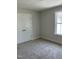 Bedroom with neutral walls, plush carpeting, a window and closet at 1039 N Lincoln St, Benson, NC 27504
