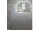 Unfinished Bonus Room with natural light streaming in from the window at 1039 N Lincoln St, Benson, NC 27504
