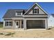 New two-story home with gray siding, open garage and covered front porch at 1039 N Lincoln St, Benson, NC 27504