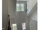 Grand foyer with elegant chandelier and staircase, offering a view of the landscaped front yard at 1039 N Lincoln St, Benson, NC 27504