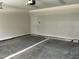 Spacious garage with concrete flooring, an interior door, and a functional layout at 1039 N Lincoln St, Benson, NC 27504