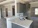 Gray kitchen featuring white countertops and an island with a sink at 1039 N Lincoln St, Benson, NC 27504