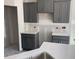 Gray kitchen featuring white countertops and cabinetry at 1039 N Lincoln St, Benson, NC 27504