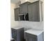 Modern kitchen featuring gray cabinets, subway tile backsplash, and stainless steel appliances at 1039 N Lincoln St, Benson, NC 27504