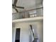 Open loft area with wood and metal railings overlooking the staircase and front entrance at 1039 N Lincoln St, Benson, NC 27504