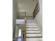Elegant staircase with light wood steps, black metal railings, and an open, airy design at 1039 N Lincoln St, Benson, NC 27504