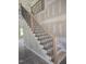 Close up of the staircase showing the black metal balusters and the natural wood handrail at 1039 N Lincoln St, Benson, NC 27504