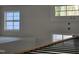 Modern staircase featuring light wood and black metal railings, with natural light from three windows at 1039 N Lincoln St, Benson, NC 27504