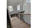 View from top of staircase, showcasing light wood treads, white risers, and a glass front door at 1039 N Lincoln St, Benson, NC 27504