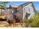Charming two-story home with blooming trees and partial view of the back porch at 105 Byron Ct, Oxford, NC 27565