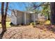Two-story home showcasing the back of the house with blooming landscaping and large lot at 105 Byron Ct, Oxford, NC 27565