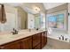 Bright bathroom features double vanity, soaking tub and stained glass window at 105 Byron Ct, Oxford, NC 27565