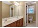 Bathroom featuring double vanity, large mirror, and toilet located in private area at 105 Byron Ct, Oxford, NC 27565
