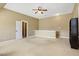 Large bonus room with neutral carpet, ceiling fan, natural light, and adjacent hall at 105 Byron Ct, Oxford, NC 27565
