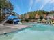 Community pool with water slide, lounge seating, and blue umbrellas at 105 Byron Ct, Oxford, NC 27565