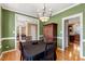 Dining room featuring green walls, hardwood floors, and an elegant chandelier at 105 Byron Ct, Oxford, NC 27565