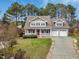 Charming two-story home featuring a welcoming front porch and a two-car garage at 105 Byron Ct, Oxford, NC 27565
