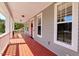 Inviting covered front porch with painted wood floor, offering a relaxing outdoor space at 105 Byron Ct, Oxford, NC 27565