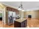 Stainless steel refrigerator beside kitchen island with overhead lighting at 105 Byron Ct, Oxford, NC 27565