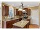 A well-appointed kitchen featuring dark wood cabinetry, granite countertops, and stainless steel appliances at 105 Byron Ct, Oxford, NC 27565