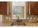 Close up of kitchen sink with granite counter tops and view of the yard from the window at 105 Byron Ct, Oxford, NC 27565