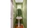 A green powder room featuring an oval mirror and pedestal sink at 105 Byron Ct, Oxford, NC 27565