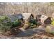 Stunning aerial view of a beautiful home with a circular driveway and lush landscaping at 10729 Trego Trl, Raleigh, NC 27614