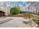 A spacious wooden deck with lounge chair offers relaxation in a wooded backyard setting at 10729 Trego Trl, Raleigh, NC 27614