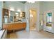 Bright bathroom with a soaking tub, modern vanity, and a glass-enclosed shower stall at 10729 Trego Trl, Raleigh, NC 27614