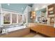 Bright bathroom with a soaking tub, modern vanity, and large windows offering serene views at 10729 Trego Trl, Raleigh, NC 27614