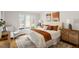 Inviting bedroom with a comfortable bed, accent pillows, and ample natural light from large windows at 10729 Trego Trl, Raleigh, NC 27614