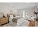 Cozy bedroom with a comfortable bed, neutral decor, and natural light from the large window at 10729 Trego Trl, Raleigh, NC 27614